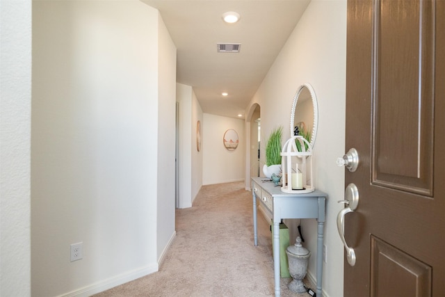 hall featuring light colored carpet