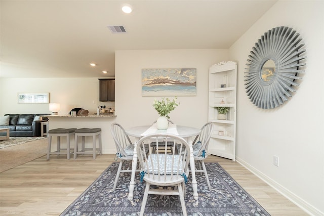 dining space with light hardwood / wood-style flooring