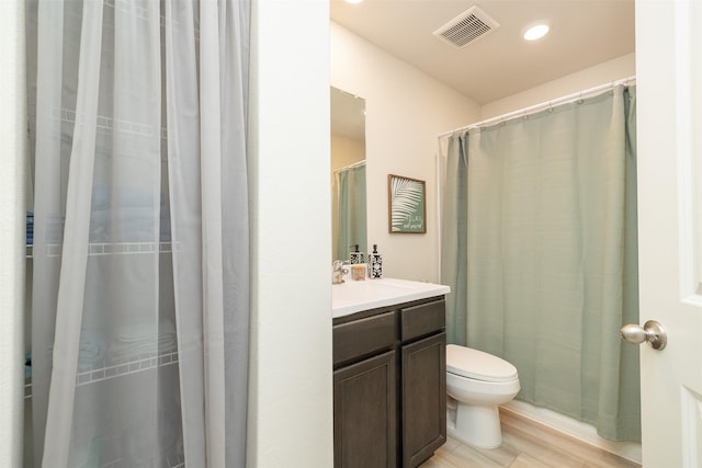 bathroom featuring hardwood / wood-style flooring, vanity, and toilet