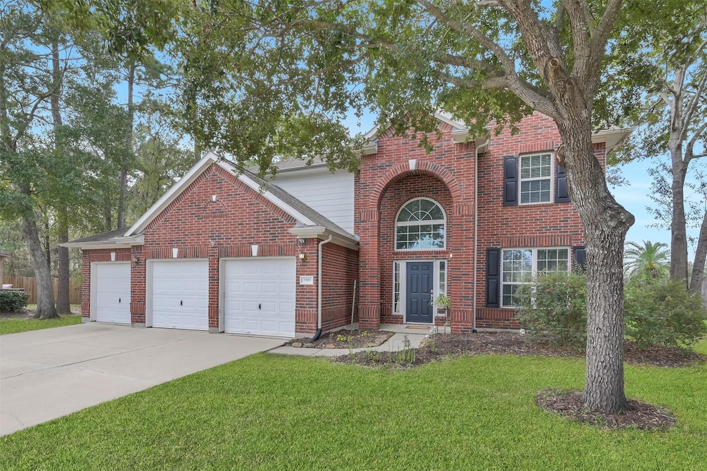 view of front of house with a garage and a front lawn