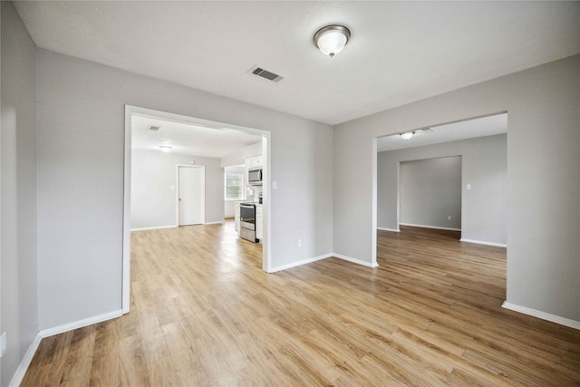 spare room with light wood-type flooring