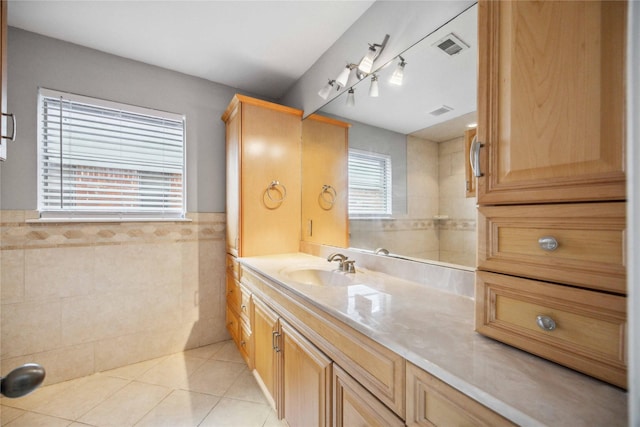 bathroom with tile patterned floors, tile walls, and vanity