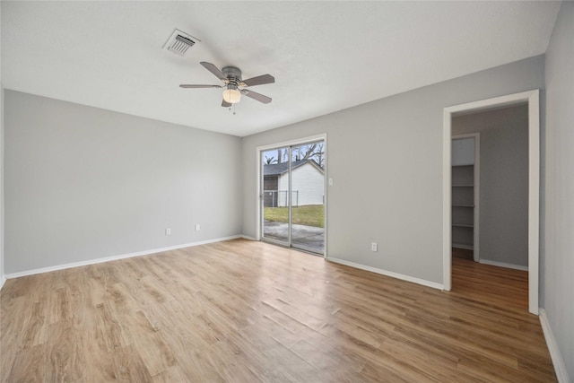 empty room featuring ceiling fan and light wood-type flooring