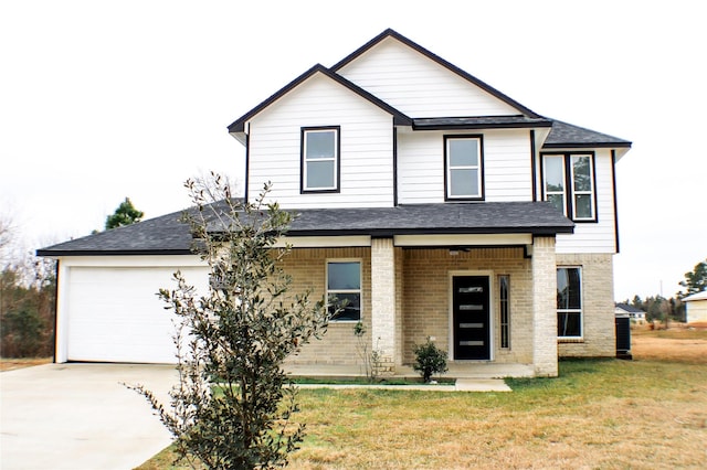 view of front of property with a garage, a front lawn, and a porch