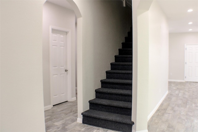 stairs featuring hardwood / wood-style flooring