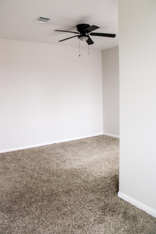 spare room featuring ceiling fan and carpet