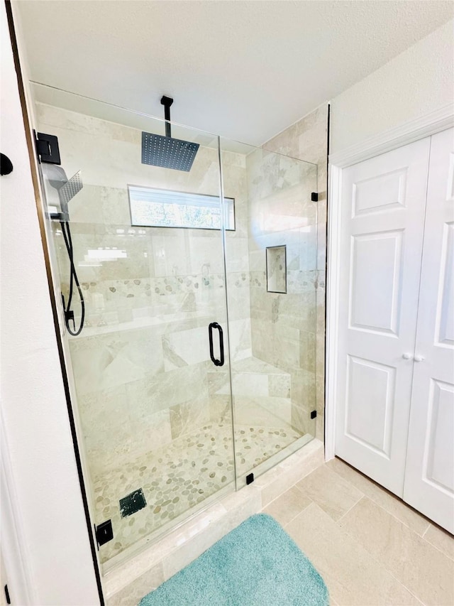 bathroom featuring a shower with door