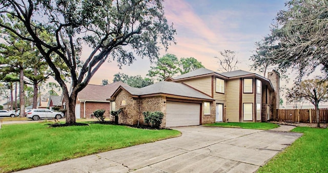 view of front of home featuring a garage and a lawn