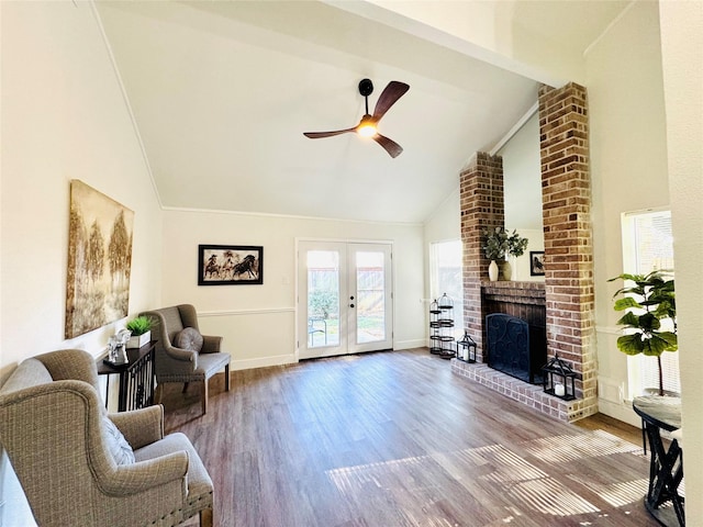 living room with french doors, high vaulted ceiling, hardwood / wood-style flooring, ceiling fan, and a fireplace