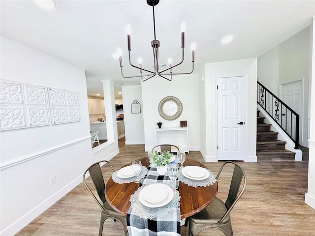 dining area featuring an inviting chandelier and light wood-type flooring