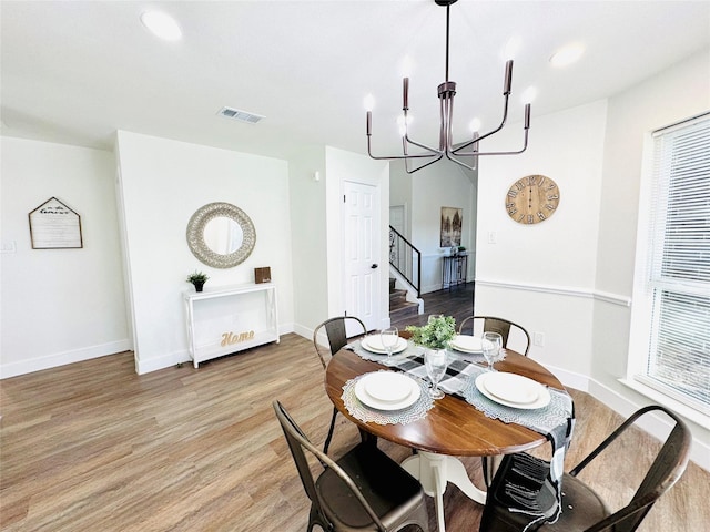 dining room featuring a chandelier and light wood-type flooring