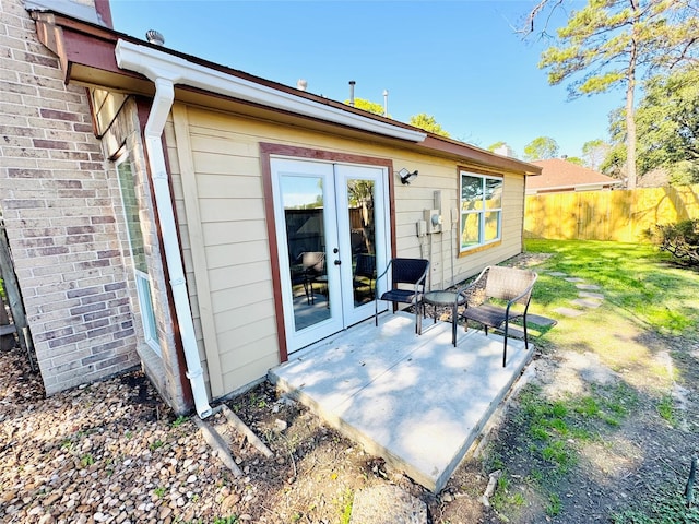 back of house featuring a patio, a yard, and french doors