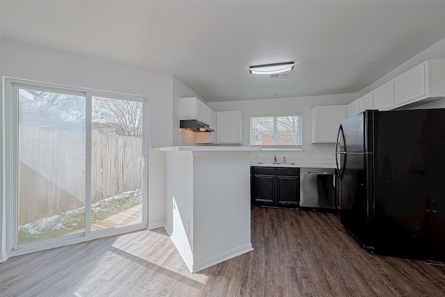 kitchen with sink, white cabinetry, black refrigerator, dark hardwood / wood-style floors, and dishwasher