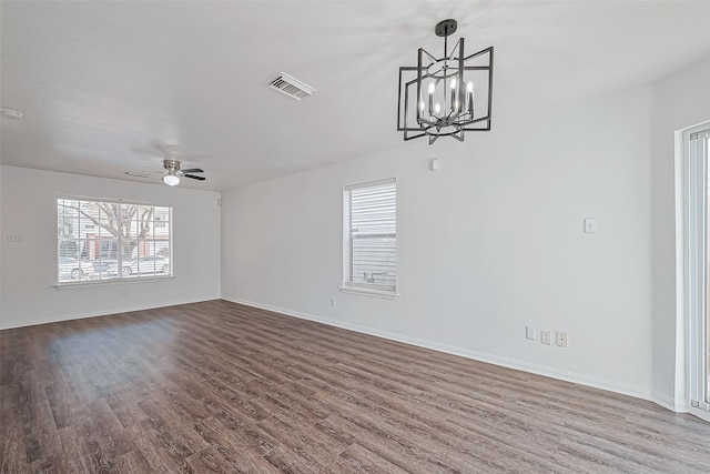 unfurnished living room featuring hardwood / wood-style floors and ceiling fan with notable chandelier