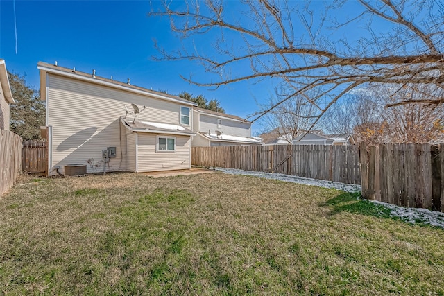 rear view of house with a yard and central AC