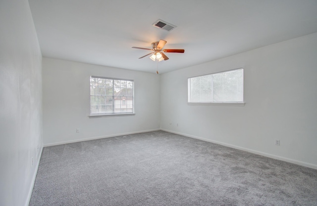 spare room featuring ceiling fan and carpet flooring