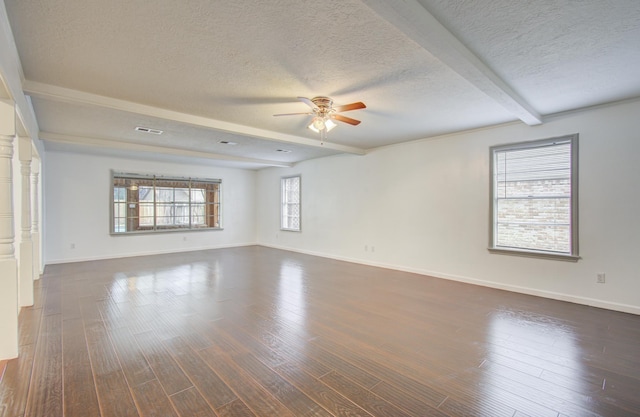 unfurnished room with beam ceiling, ceiling fan, dark hardwood / wood-style floors, and a textured ceiling