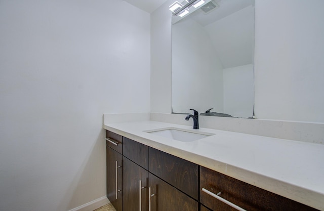 bathroom featuring vanity and vaulted ceiling