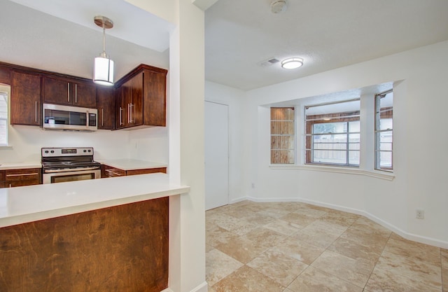 kitchen with hanging light fixtures, appliances with stainless steel finishes, and dark brown cabinetry