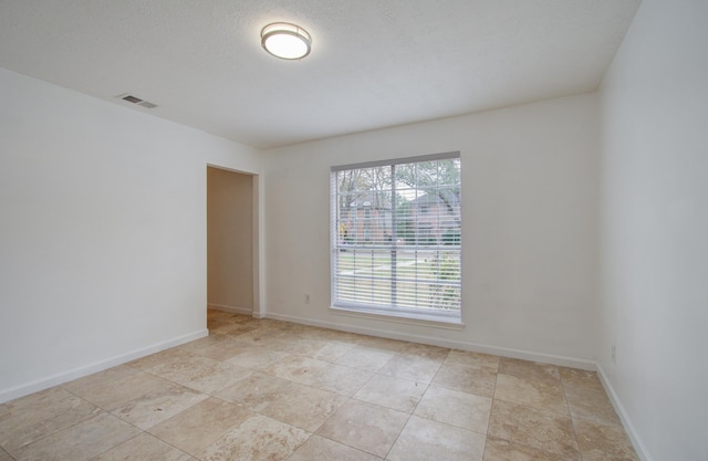 spare room with a textured ceiling