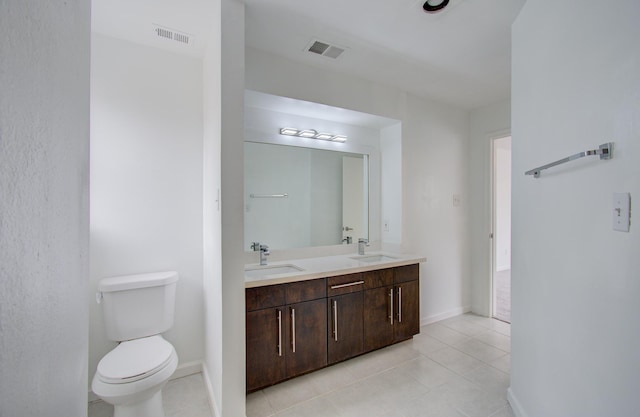 bathroom featuring tile patterned floors, vanity, and toilet