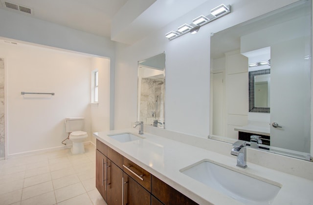 bathroom featuring tile patterned floors, vanity, and toilet