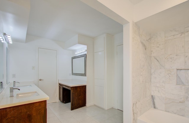 bathroom featuring vanity, a washtub, and tile patterned floors