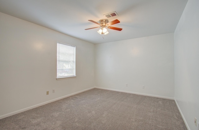 empty room with ceiling fan and carpet flooring