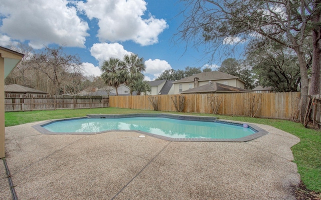 view of swimming pool featuring a patio and a yard