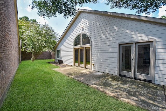 rear view of property with a patio and a lawn