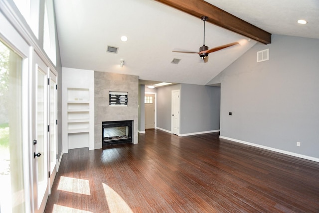 unfurnished living room featuring built in shelves, vaulted ceiling with beams, dark hardwood / wood-style flooring, ceiling fan, and a fireplace