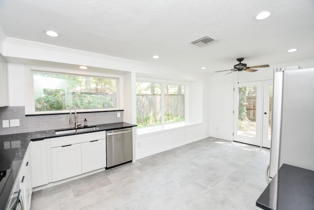 kitchen with sink, white cabinetry, tasteful backsplash, refrigerator, and dishwasher