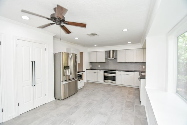 kitchen with wall chimney exhaust hood, appliances with stainless steel finishes, crown molding, and backsplash