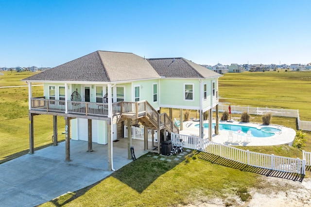 back of house featuring a fenced in pool, a yard, central AC unit, a patio area, and a garage