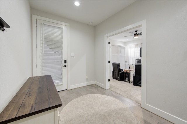 entryway with ceiling fan and light hardwood / wood-style flooring