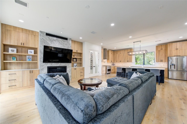 living room featuring a fireplace and light hardwood / wood-style flooring