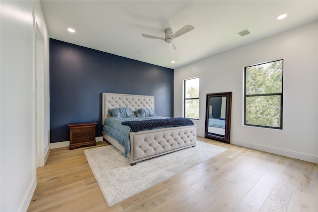 bedroom with ceiling fan and light hardwood / wood-style floors