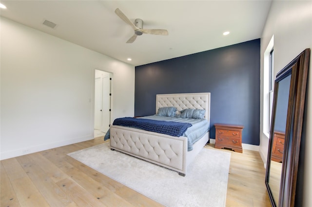 bedroom with light hardwood / wood-style floors and ceiling fan