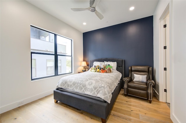 bedroom with ceiling fan and light hardwood / wood-style flooring