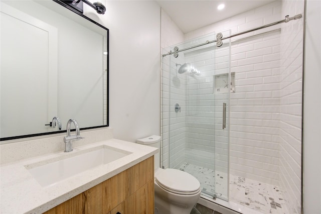 bathroom with vanity, toilet, and walk in shower