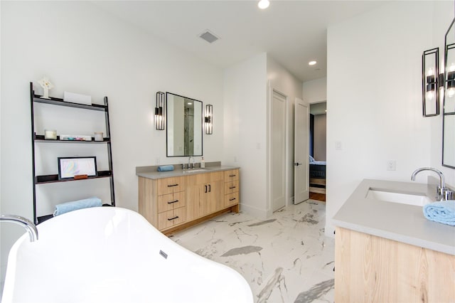 bathroom with vanity and a bath