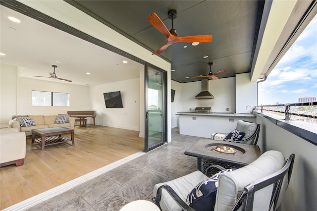 exterior space featuring an outdoor living space with a fire pit and ceiling fan