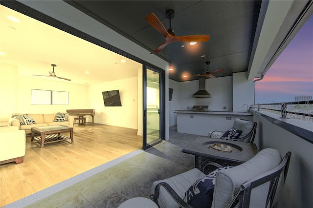 balcony at dusk with an outdoor living space and ceiling fan