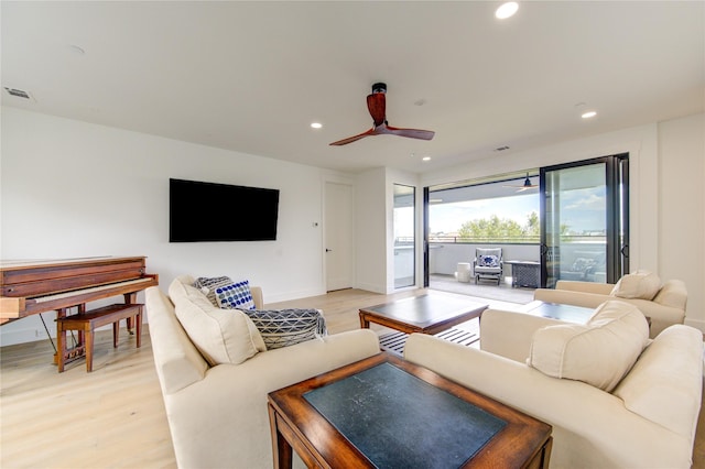 living room featuring ceiling fan and light wood-type flooring