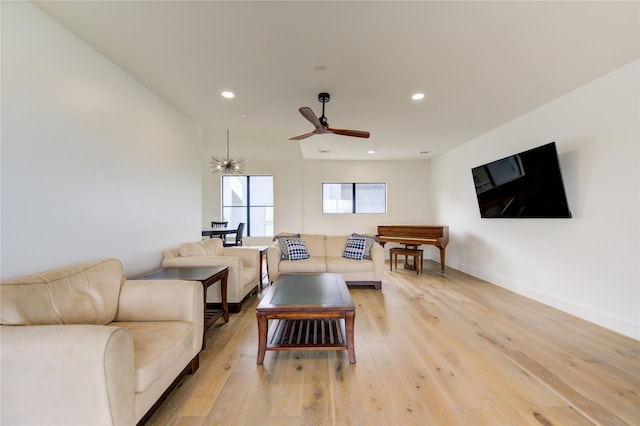 living room with ceiling fan and light hardwood / wood-style flooring