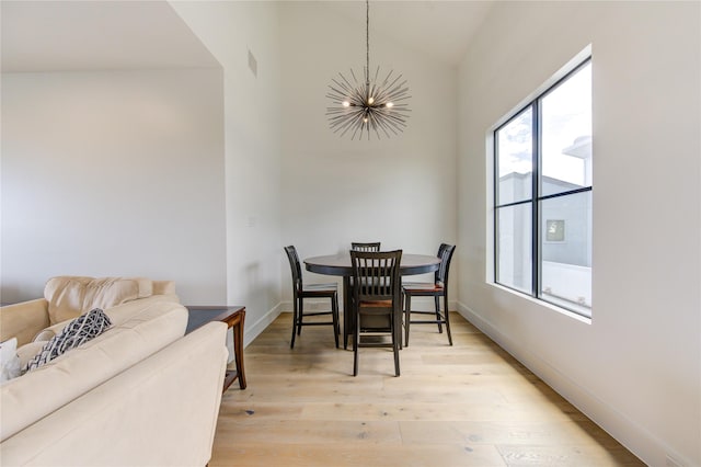 dining area featuring hardwood / wood-style flooring and a chandelier