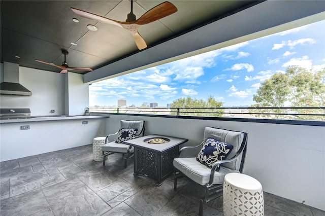 view of patio with ceiling fan, area for grilling, and a fire pit