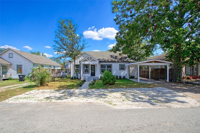 view of front of home with a carport and a front lawn