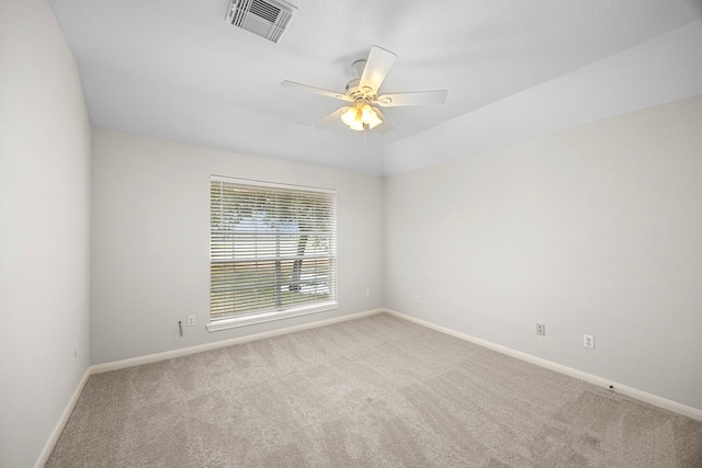 carpeted spare room featuring ceiling fan