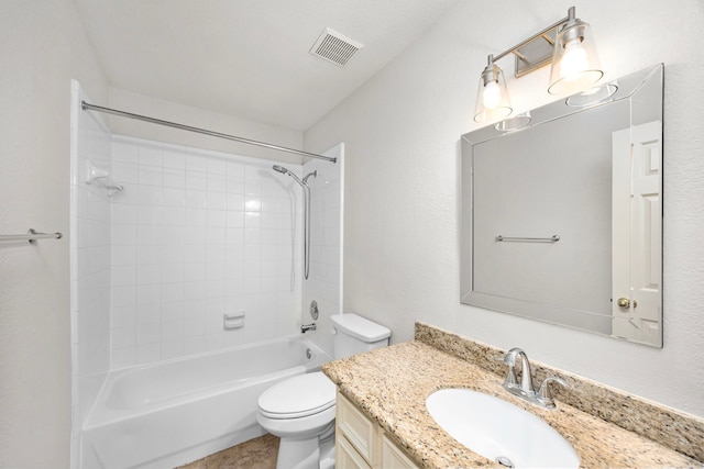 full bathroom with tiled shower / bath, vanity, and toilet